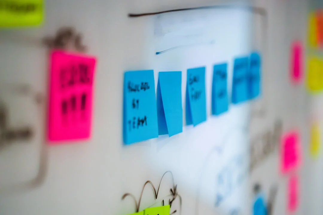 Creative display of the word OPTIMIZE on a pink textured surface.